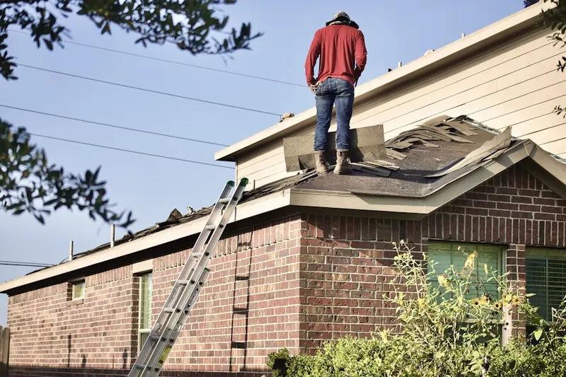 Professional roofer working on a residential roof in Waggoner Trace